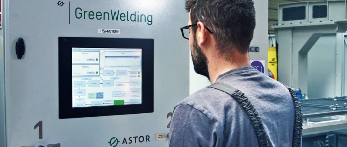 An operator during handling of a welding station control panel
